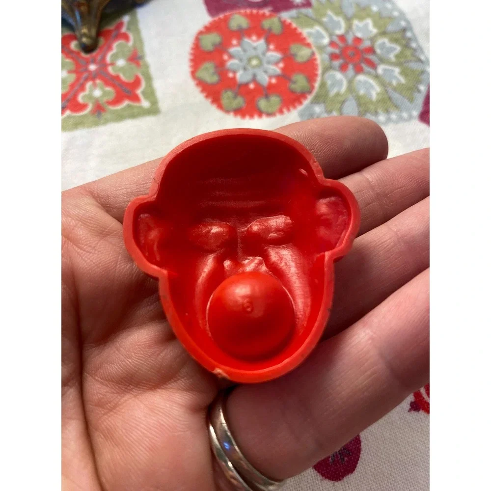 Vintage Red Plastic Monkey Head Novelty Toy with Removable Silver Ball Charm